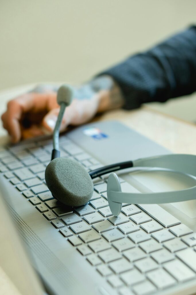 Close-up of a headset on a laptop keyboard, representing remote work and customer support.